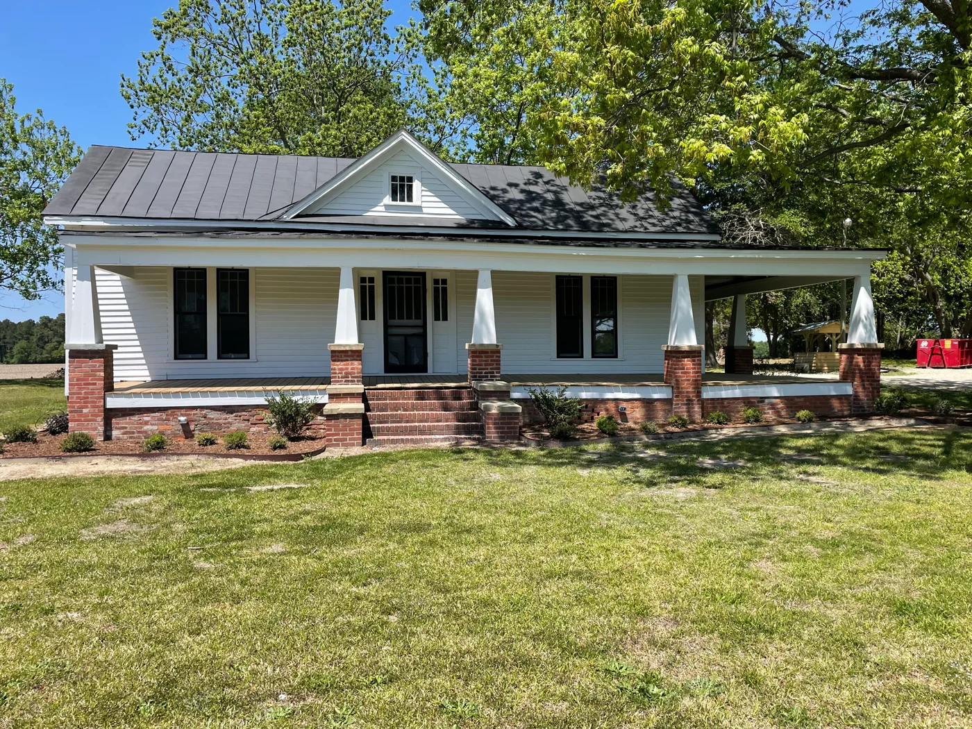 The white Davis family farmhouse with its shaded front porch